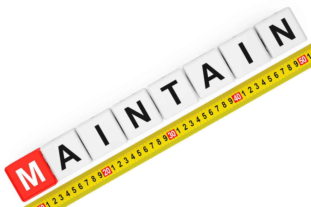 Measure Maintain Concept. Maintain Cubes With Measuring Tape