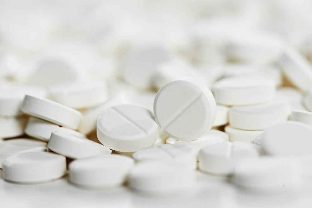 Pharmacy theme, Heap of white round medicine tablet antibiotic pills. Very Shallow DOF